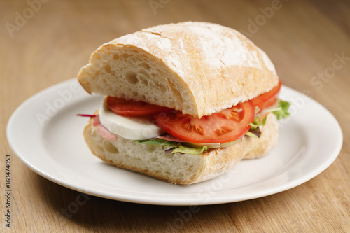 ciabatta sandwich with speck, mozzarella and vegetables