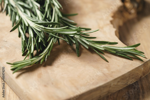 fresh rosemary bunch on wood table