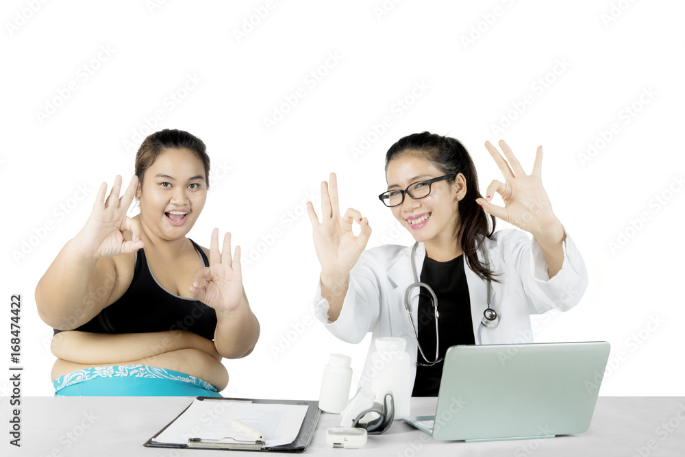 Doctor and overweight patient show OK sign Doctor and overweight patient show OK sign