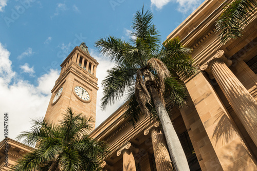 Brisbane City Hall with clock tower and palm trees