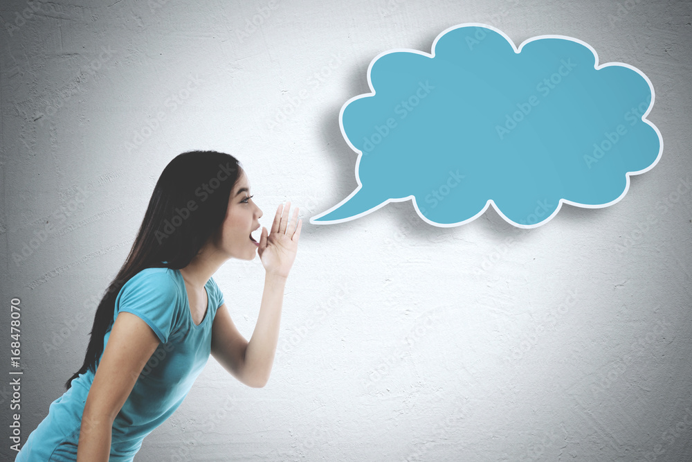 Young woman whispering to an empty cloud Young woman whispering to an empty cloud