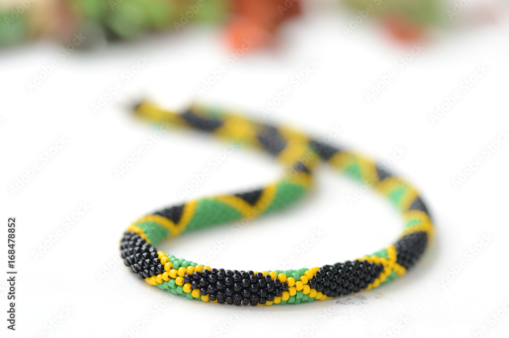 Obraz premium Bead crochet necklace in jamaican style close up