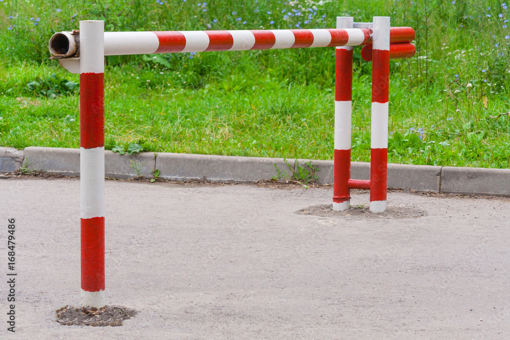 Metal red white barrier on the road Metal red white barrier on the road