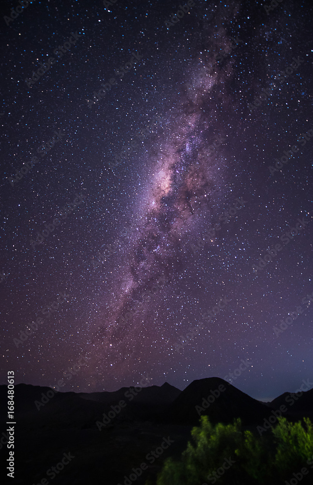 Landscape with Milky way galaxy over Mount Bromo volcano (Gunung Bromo) in Bromo Tengger Semeru National Park, East Java, Indonesia. Night sky with stars. Long exposure photograph.