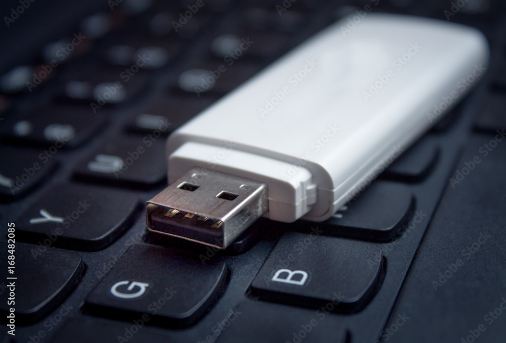 USB Flash drive on computer laptop keyboard. USB Flash drive on computer laptop keyboard.