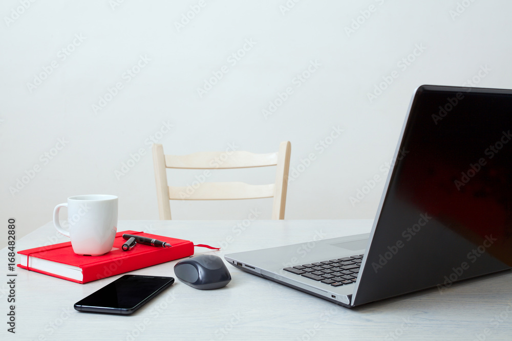 Clean workplace with laptop,phone,notebook,coffee cup and computer mouse - obrazy, fototapety, plakaty 