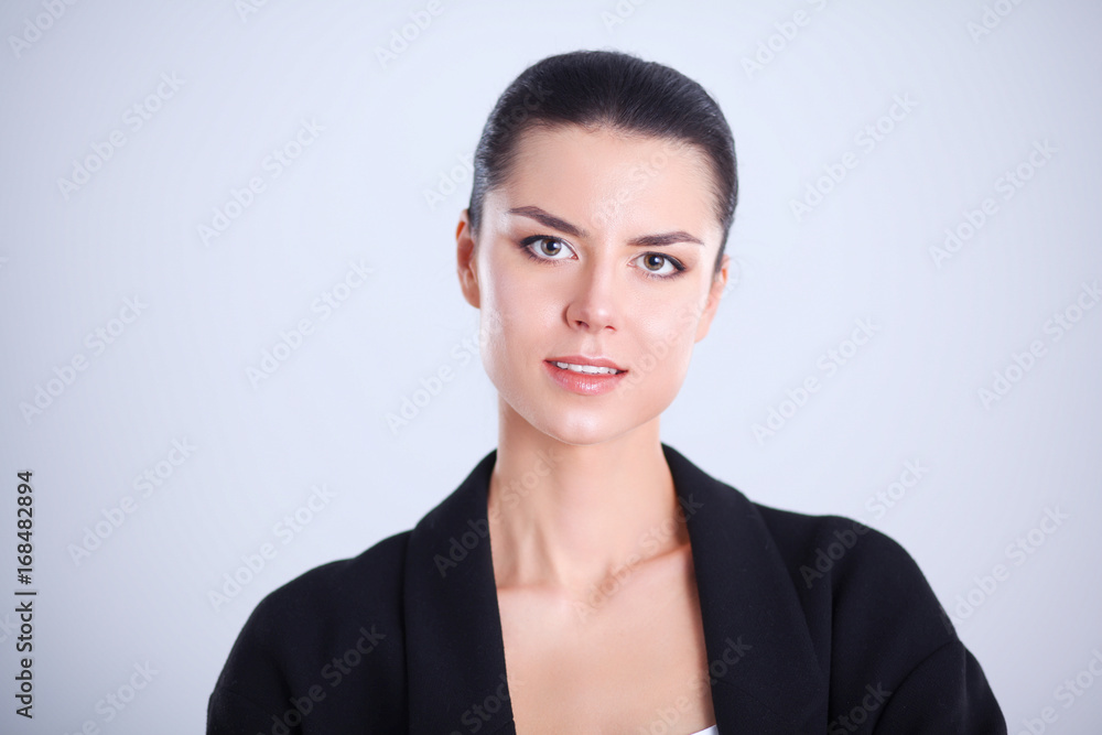 Young woman standing, isolated on gray background Young woman standing, isolated on gray background