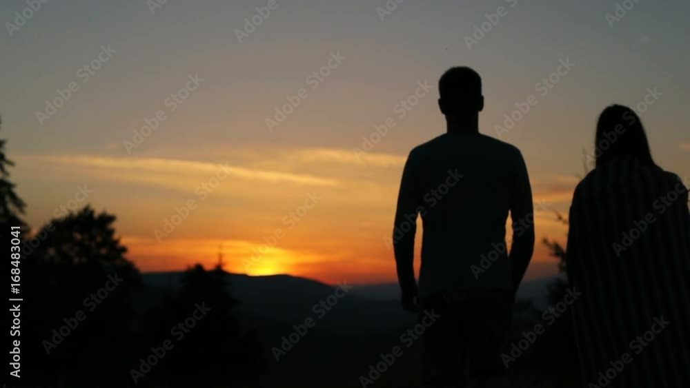 Silhouette male female person walking standing evening sunset beautiful sky fiery background nature hugging shoulders peaceful friends young lovely pair beholding looking horizon free idyllic space Silhouette male female person walking standing evening sunset beautiful sky fiery background nature hugging shoulders peaceful friends young lovely pair beholding looking horizon free idyllic space