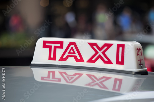 Taxi cab sign on roof of a taxi