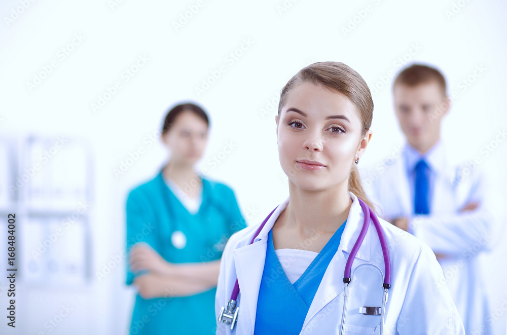 Attractive female doctor in front of medical group Attractive female doctor in front of medical group