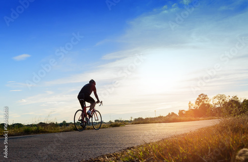 cyclist in motion on the background of beautiful sunset,ride bicycle on sunset background, A man ride a bike in sunset background.