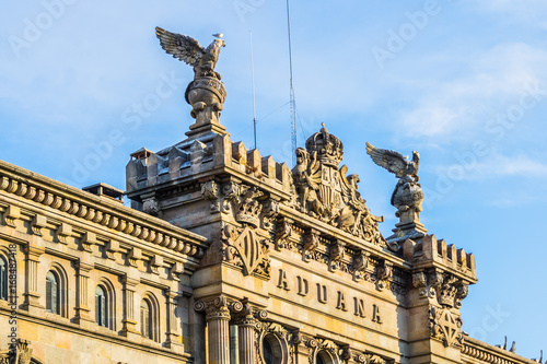 Architectural fragment of Aduana de Barcelona, old customs building (designed by Sagnier i Villavecchia, 1902) in neoclassical style at Port Vell. Late afternoon. Barcelona, Catalonia, Spain, Europe. photo