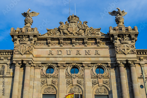Architectural fragment of Aduana de Barcelona, old customs building (designed by Sagnier i Villavecchia, 1902) in neoclassical style at Port Vell. Late afternoon. Barcelona, Catalonia, Spain, Europe. photo