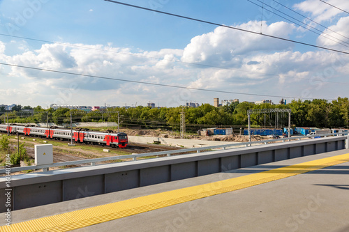 Passenger long-distance train rides under the bridge  