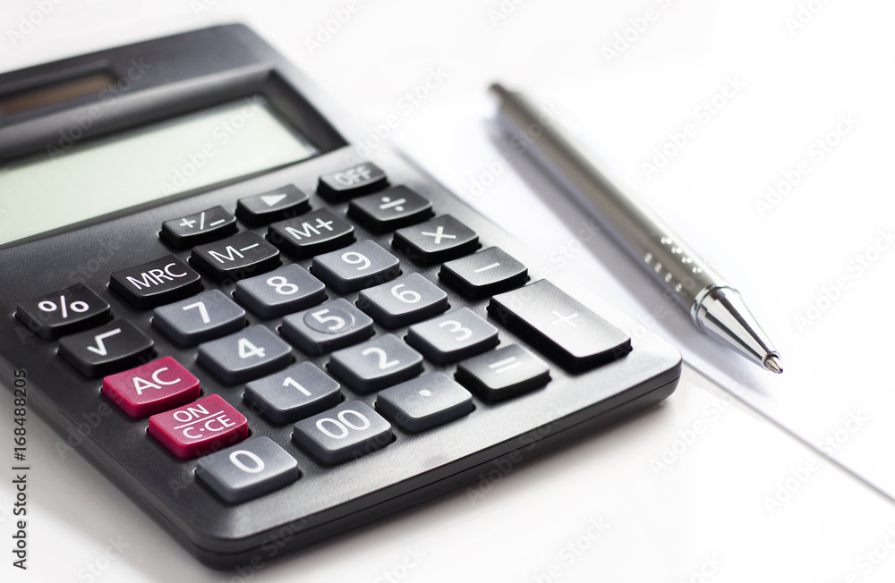 calculator and pen on white table.concept work and education calculator and pen on white table.concept work and education