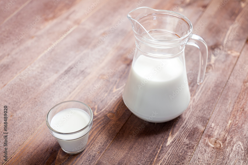 milk and glasses of milk on a wooden rustic table. milk and glasses of milk on a wooden rustic table.