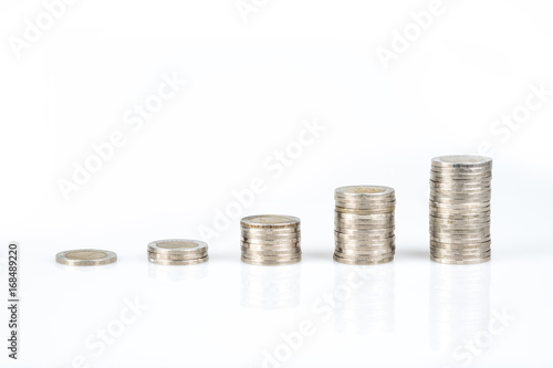 Savings, business growth, financial stability concept by several stacks of coins on white background.