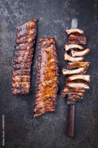 Barbecue pork spare ribs as top view on an old rusty board