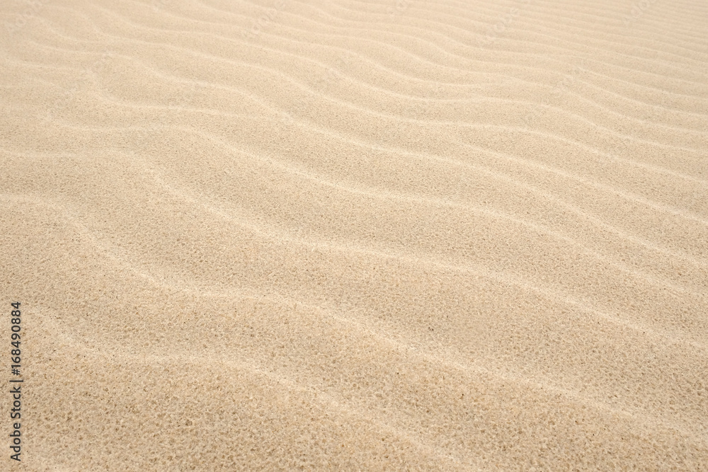 Natural background of sand in ripple wave pattern Natural background of sand in ripple wave pattern