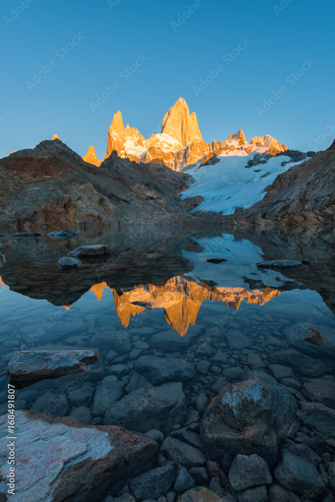 Reflection of Mount Cerro Fitz Roy in the water of the glacial lake Laguna de Los Tres at dawn. Argentina, Patogonia.