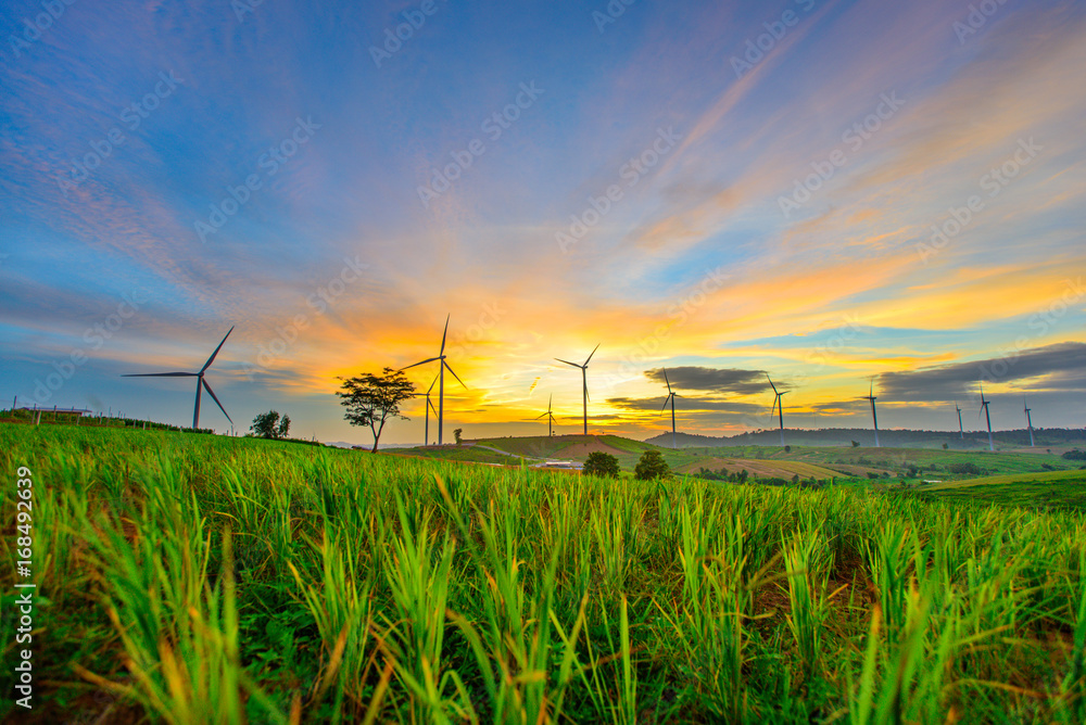 Wind generators turbines at sunset. Beautiful mountain landscape with wind generators turbines at Khao Kho mountain, Thailand. Renewable energy concept. Wind generators turbines at sunset. Beautiful mountain landscape with wind generators turbines at Khao Kho mountain, Thailand. Renewable energy concept.