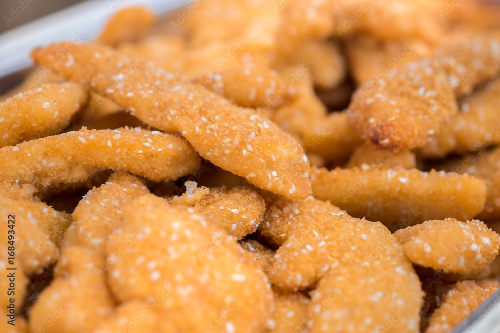 Lot of golden chicken schnitzels with sesame Lot of golden chicken schnitzels with sesame