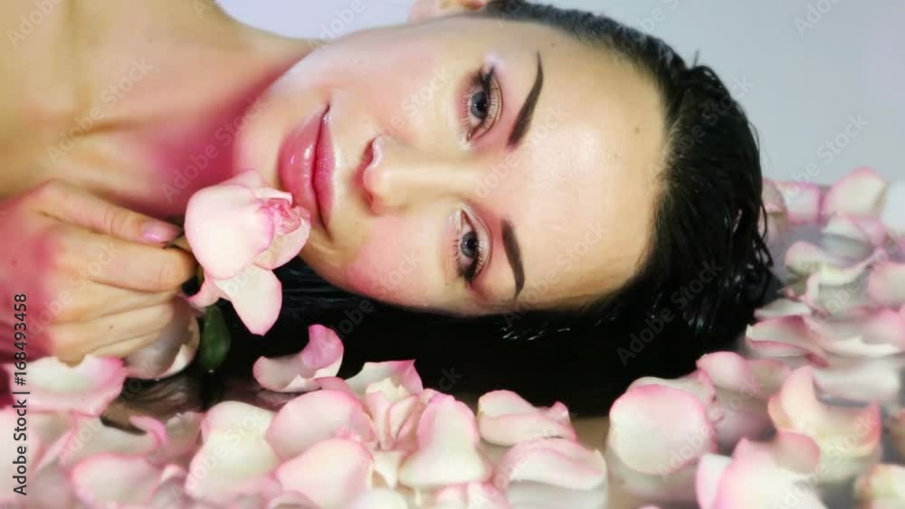 Woman with Fresh Rose petals and pink rosebud. Natural Rose water Woman with Fresh Rose petals and pink rosebud. Natural Rose water