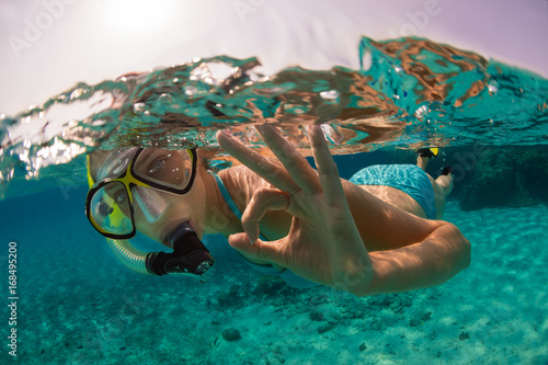 Snorkeling woman exploring beautiful ocean sealife, underwater photography.