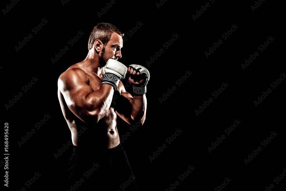 Sportsman muay thai boxer fighting in boxing cage. Isolated on black background. Box trainer on ring hitting Sportsman muay thai boxer fighting in boxing cage. Isolated on black background. Box trainer on ring hitting