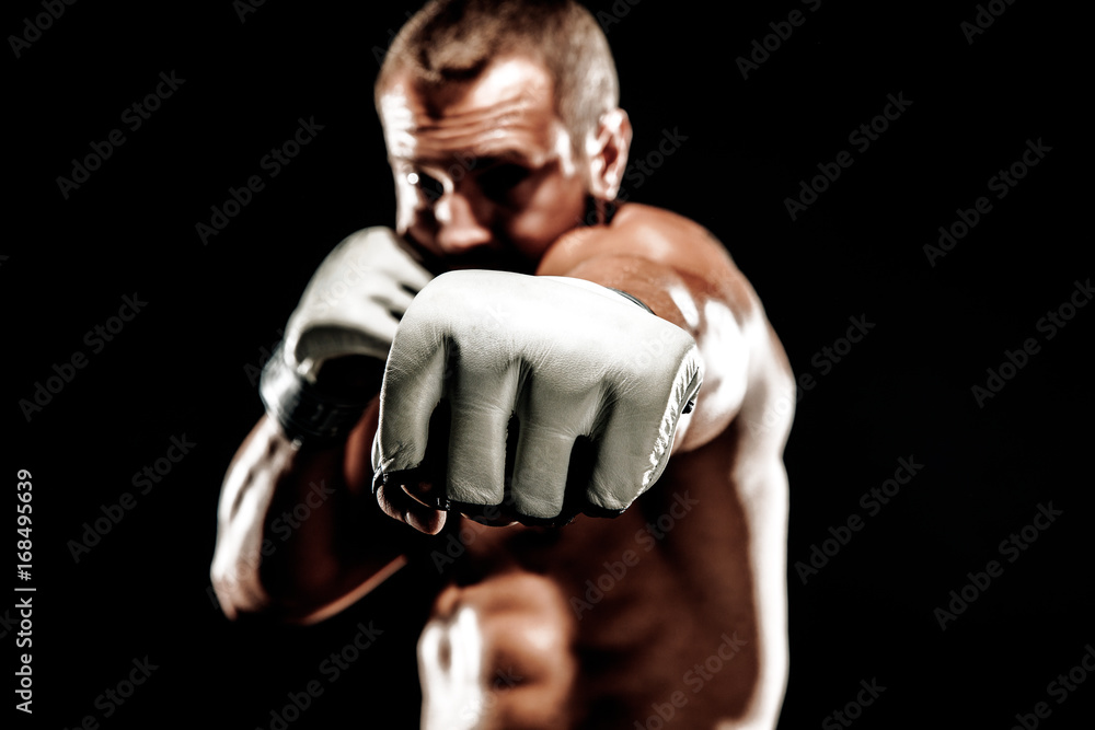Sportsman muay thai boxer fighting in boxing cage. Isolated on black background. Box trainer on ring hitting Sportsman muay thai boxer fighting in boxing cage. Isolated on black background. Box trainer on ring hitting