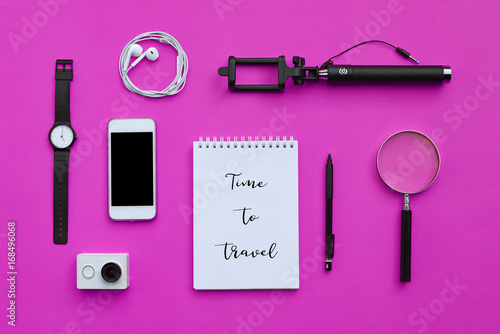 Flat lay of accessories on pink desk background of photographer