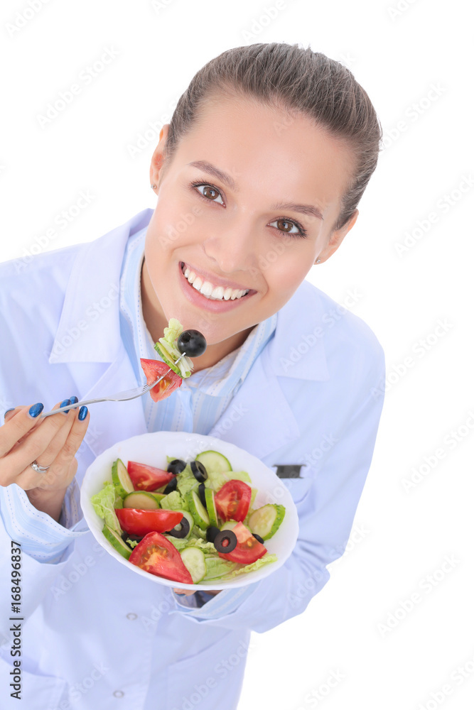 Portrait of a beautiful woman doctor holding a plate with fresh vegetables. Woman doctors. Portrait of a beautiful woman doctor holding a plate with fresh vegetables. Woman doctors.