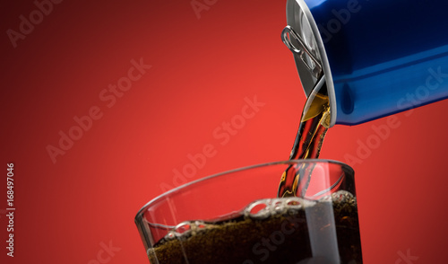 Obraz na plátně Pouring a soft drink in a glass