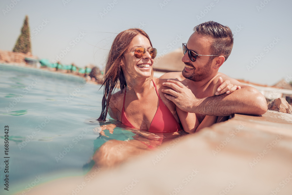 Fototapeta premium Couple relaxing in swimming pool