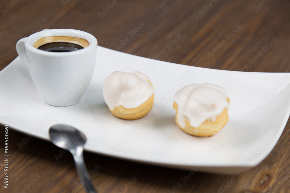 bignè and coffee on white dish bignè and coffee on white dish