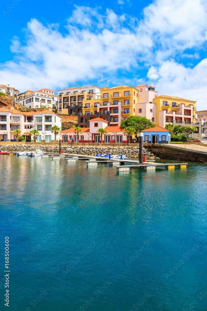 View of sailing marina with colourful houses near Canical town on coast of Madeira island, Portugal