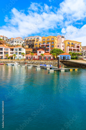 View of sailing marina with colourful houses near Canical town on coast of Madeira island, Portugal