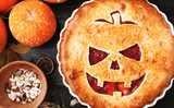 Delicious homemade pie for halloween with a filling of pumpkin-strawberry jam and peaches