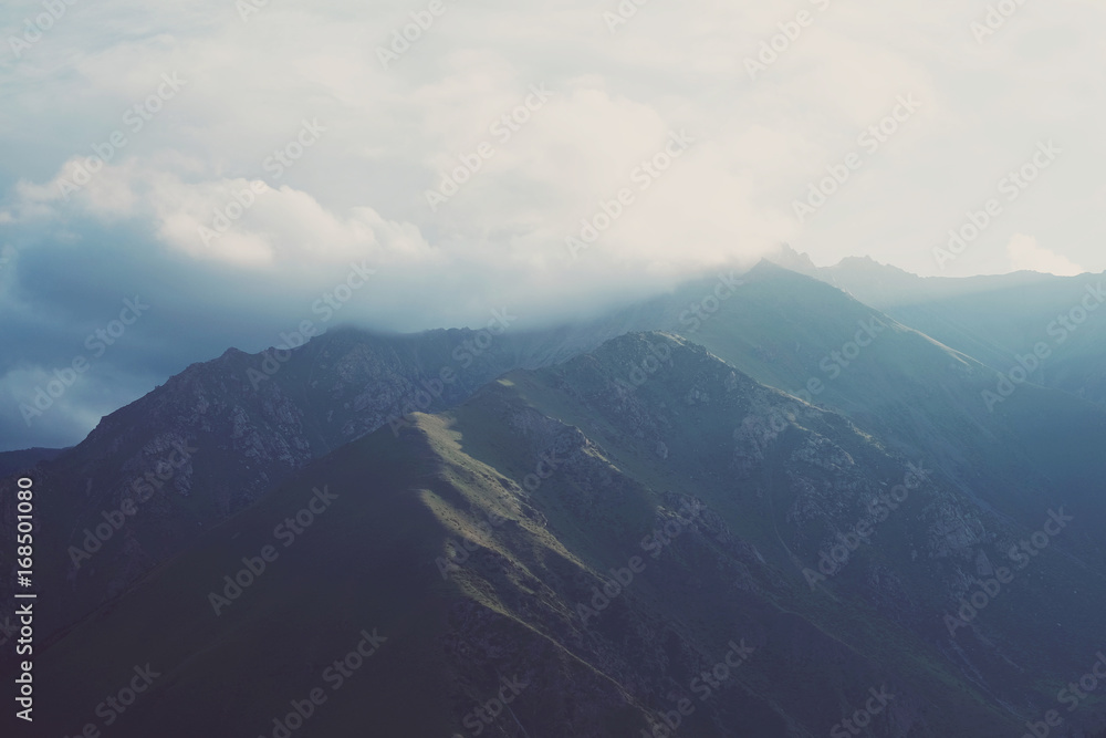 Fototapeta premium Dawn and mountains in the clouds