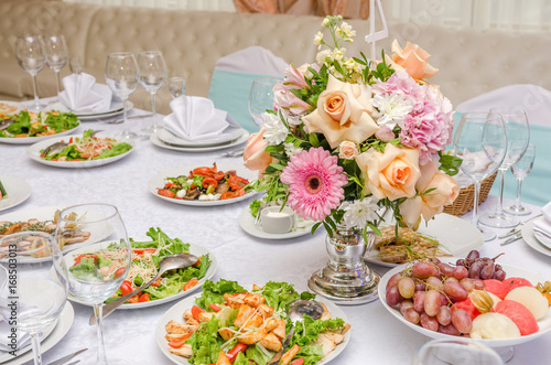 Banquet table in a restaurant with flowers. Wedding decorated