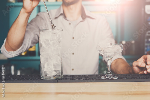 Bartender making ice for cocktail closeup