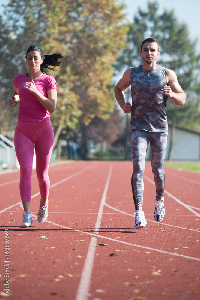 Athlete Couple Sprinting on the Running Track