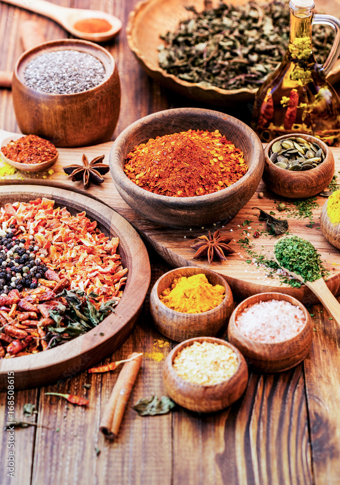 Spices and Herbs on Wooden Background