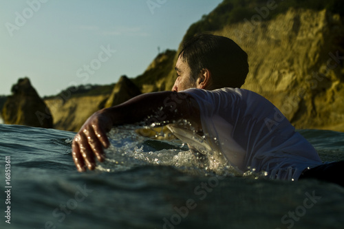 Surfer paddles off coast of South America