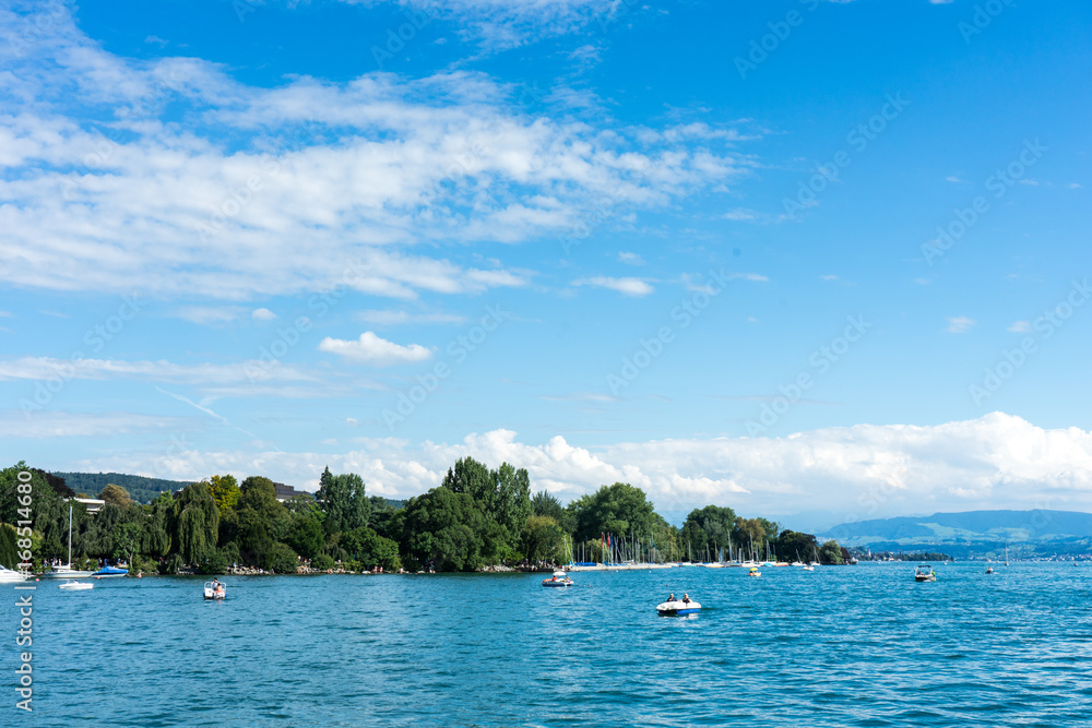 Fototapeta premium lake water view with urban city area and mountain and blue sky