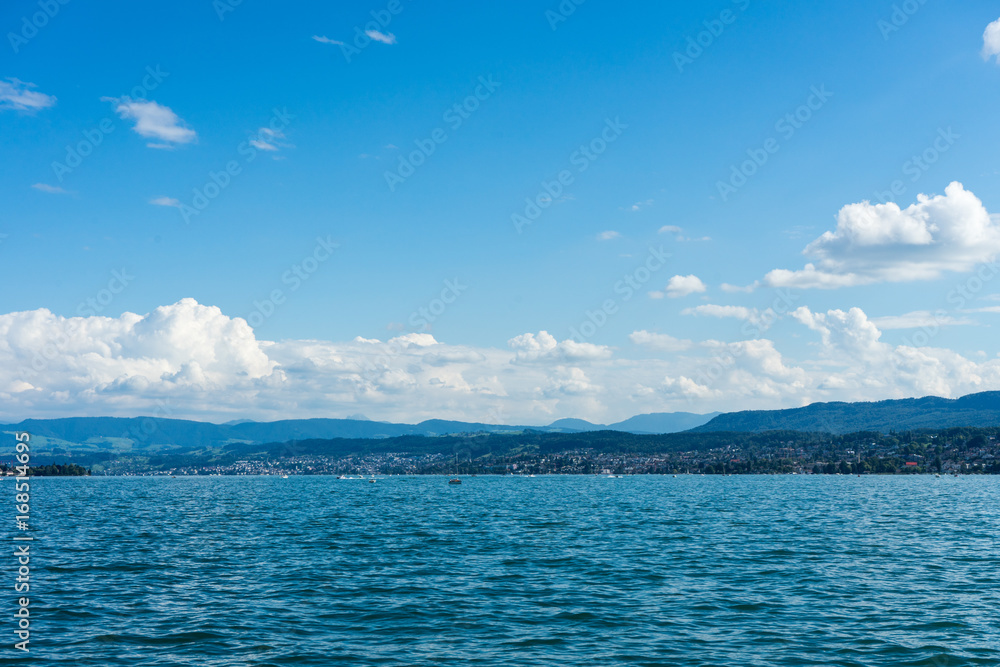 lake water view with urban city area and mountain and blue sky