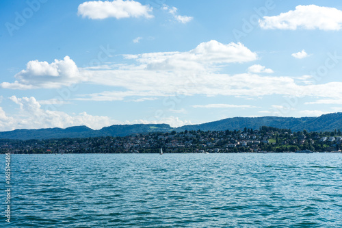 lake water view with urban city area and mountain and blue sky