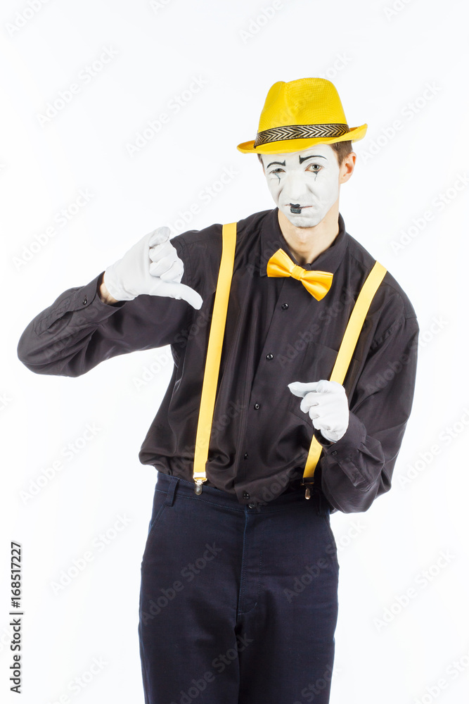 Portrait of a man, actor, pantomime, looking at camera and showing thumb down. Portrait of a man, actor, pantomime, looking at camera and showing thumb down.