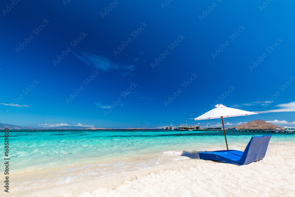 Beautiful beach. Sunbeds with umbrella on the sandy beach near the sea. Summer holiday and vacation concept. Inspirational tropical beach. Beautiful beach. Sunbeds with umbrella on the sandy beach near the sea. Summer holiday and vacation concept. Inspirational tropical beach.