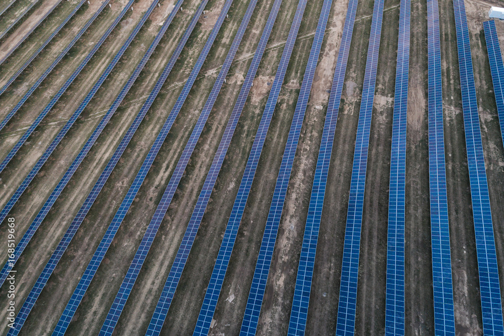 Series of solar cells located on the field in the suburbs. Aerial view. Alternative sources of energy. Series of solar cells located on the field in the suburbs. Aerial view. Alternative sources of energy.